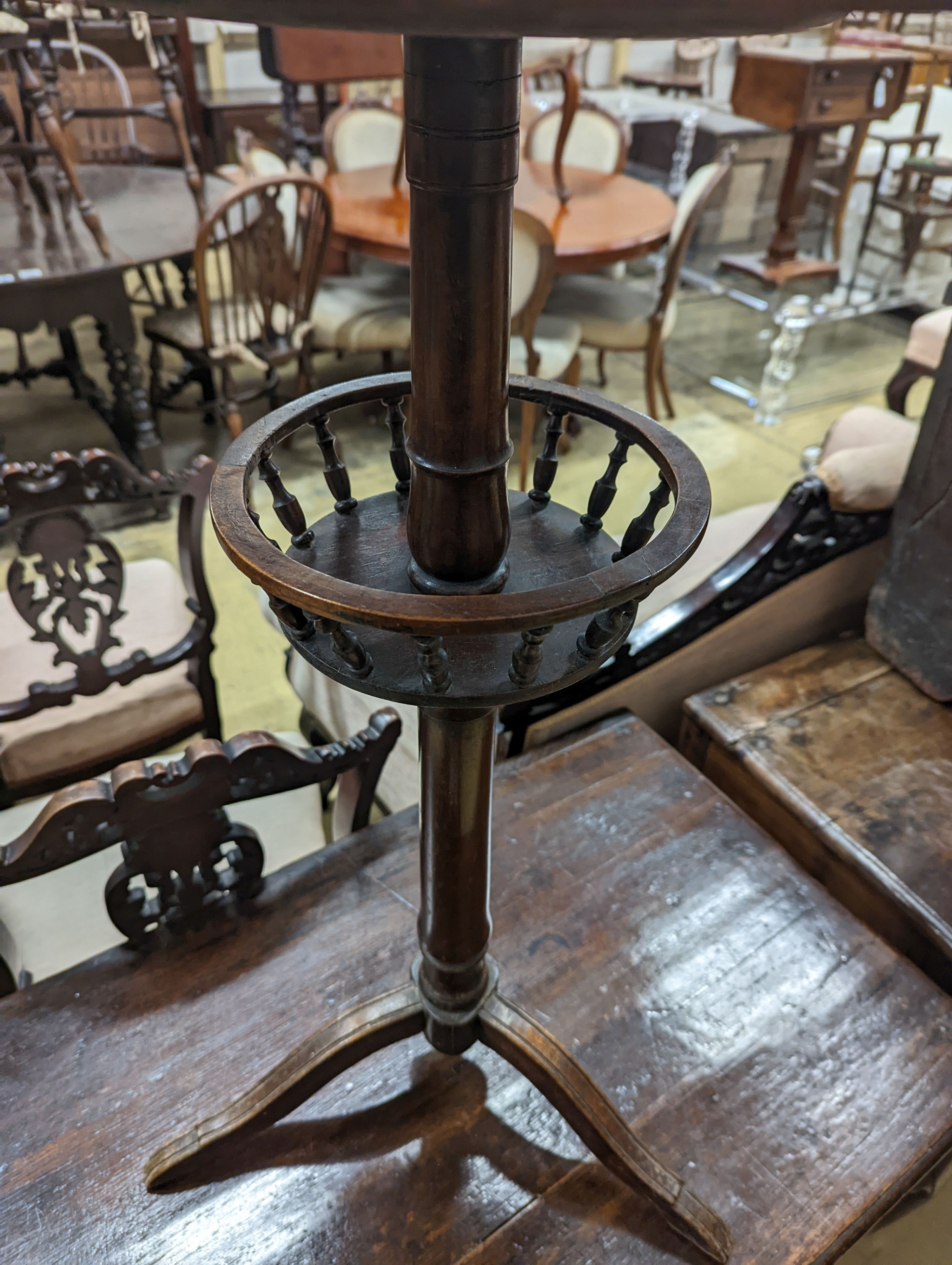 An early 19th century primitive circular tripod table, diameter 42cm, height 73cm